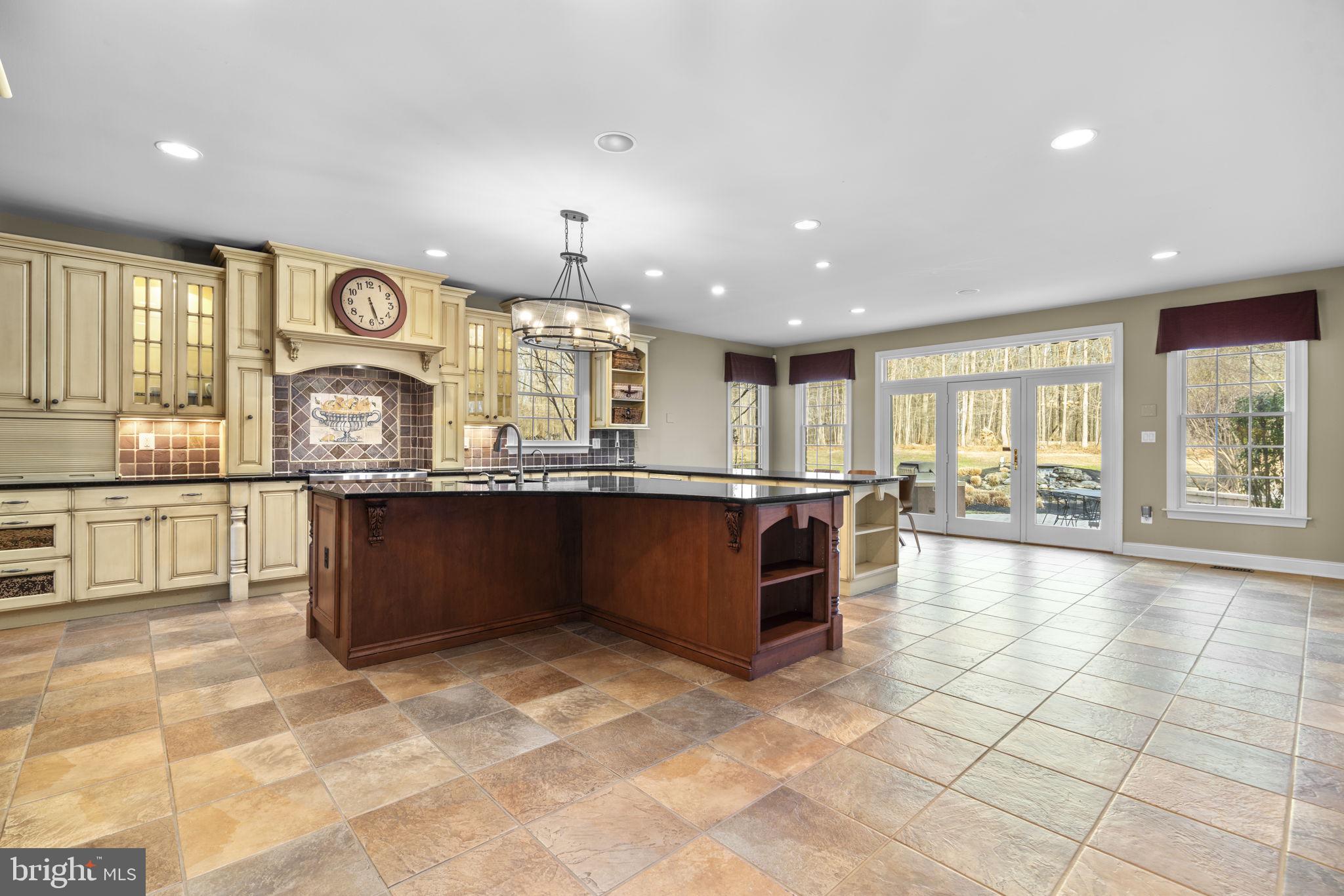 3091 Emerald Valley Road Ellicott City, MD 21042 - Photo 11 of 95 a large kitchen with a large counter top and stainless steel appliances