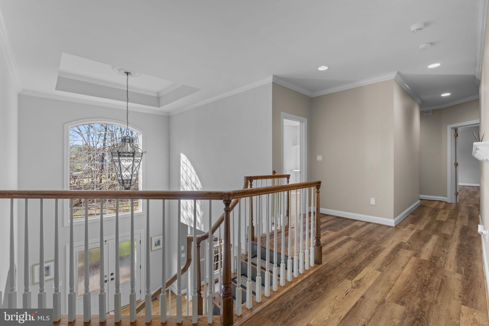 3091 Emerald Valley Road Ellicott City, MD 21042 - Photo 33 of 95 a view of hallway with wooden floor and stairs
