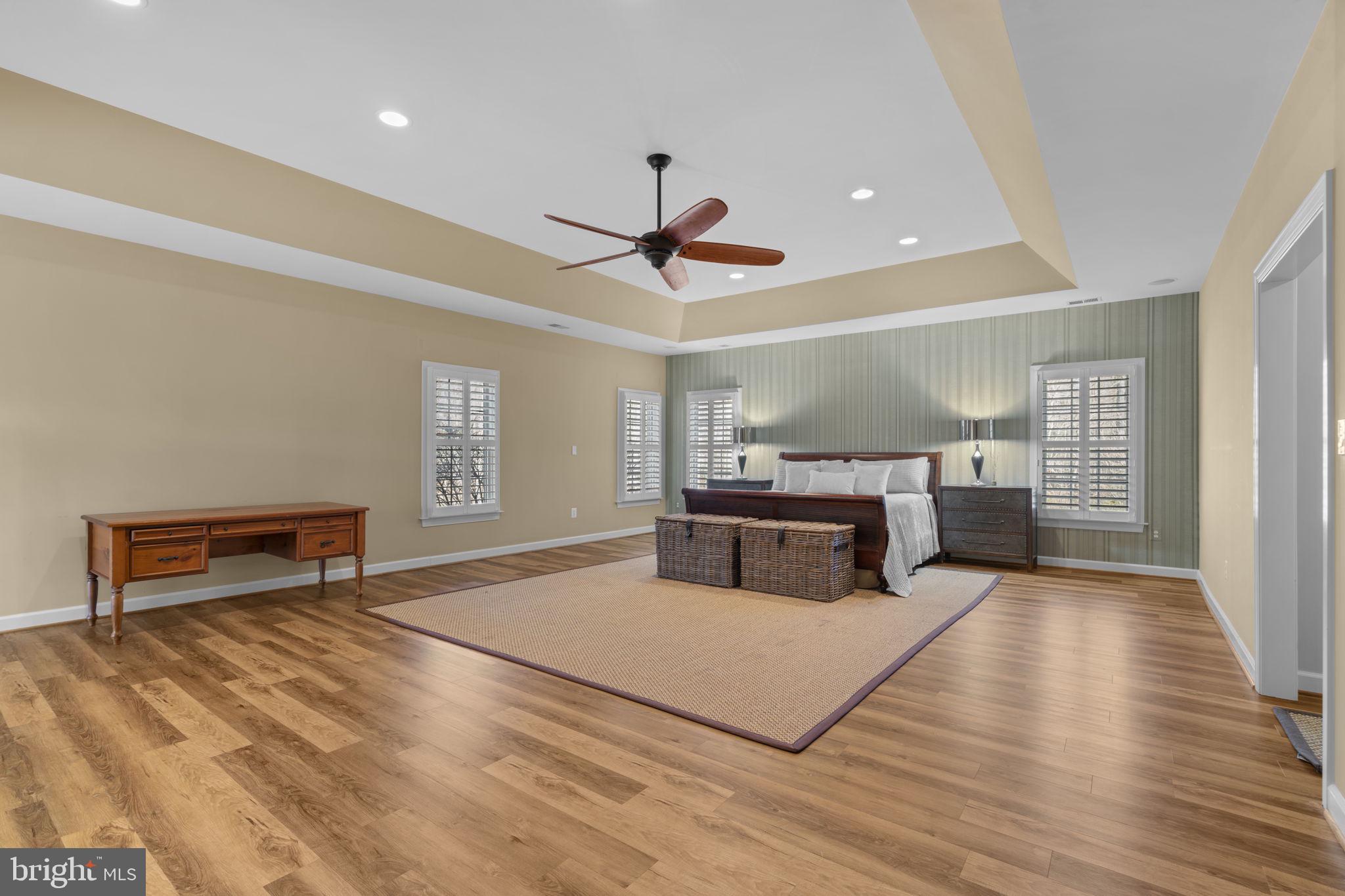 3091 Emerald Valley Road Ellicott City, MD 21042 - Photo 34 of 95 a spacious bedroom with a bed and a chandelier