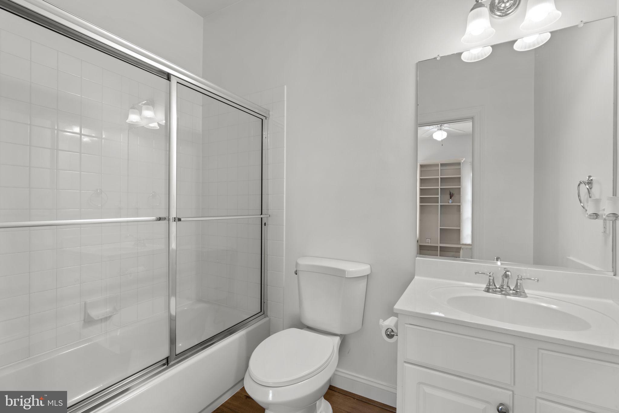 3091 Emerald Valley Road Ellicott City, MD 21042 - Photo 55 of 95 a bathroom with a toilet a sink a mirror and shower