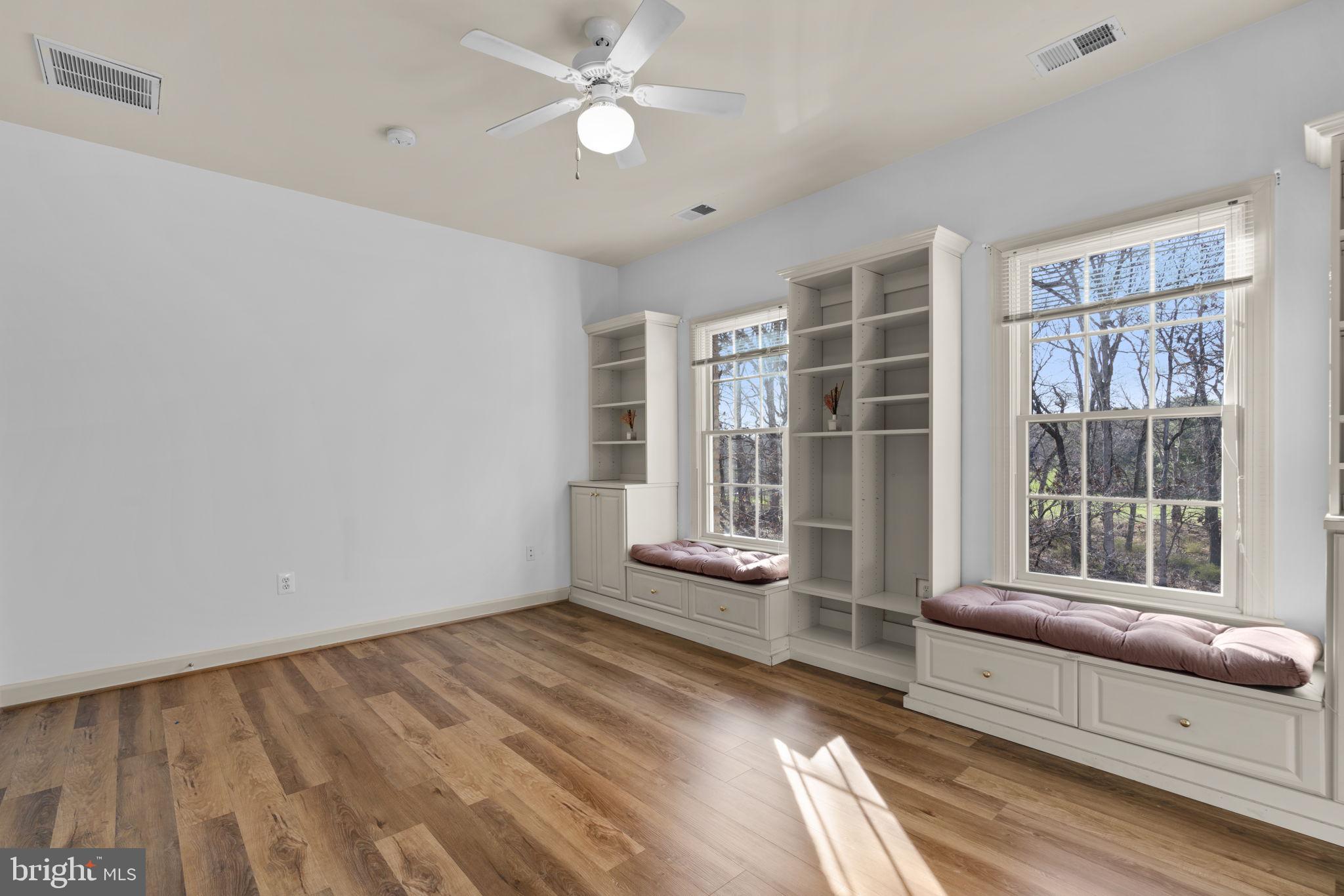 3091 Emerald Valley Road Ellicott City, MD 21042 - Photo 58 of 95 a view of an empty room with a window and wooden floor