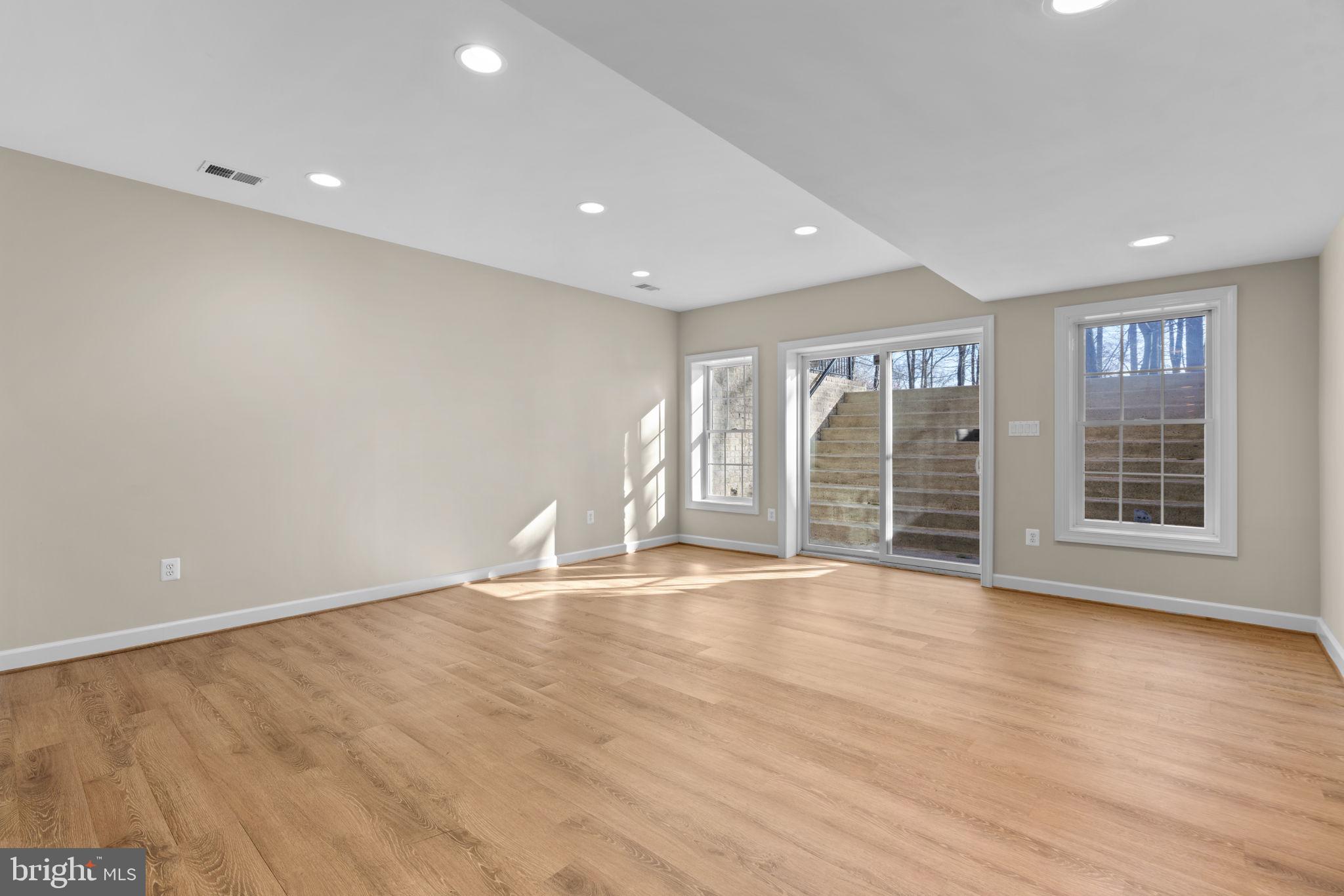 3091 Emerald Valley Road Ellicott City, MD 21042 - Photo 61 of 95 a view of an empty room with wooden floor and a window