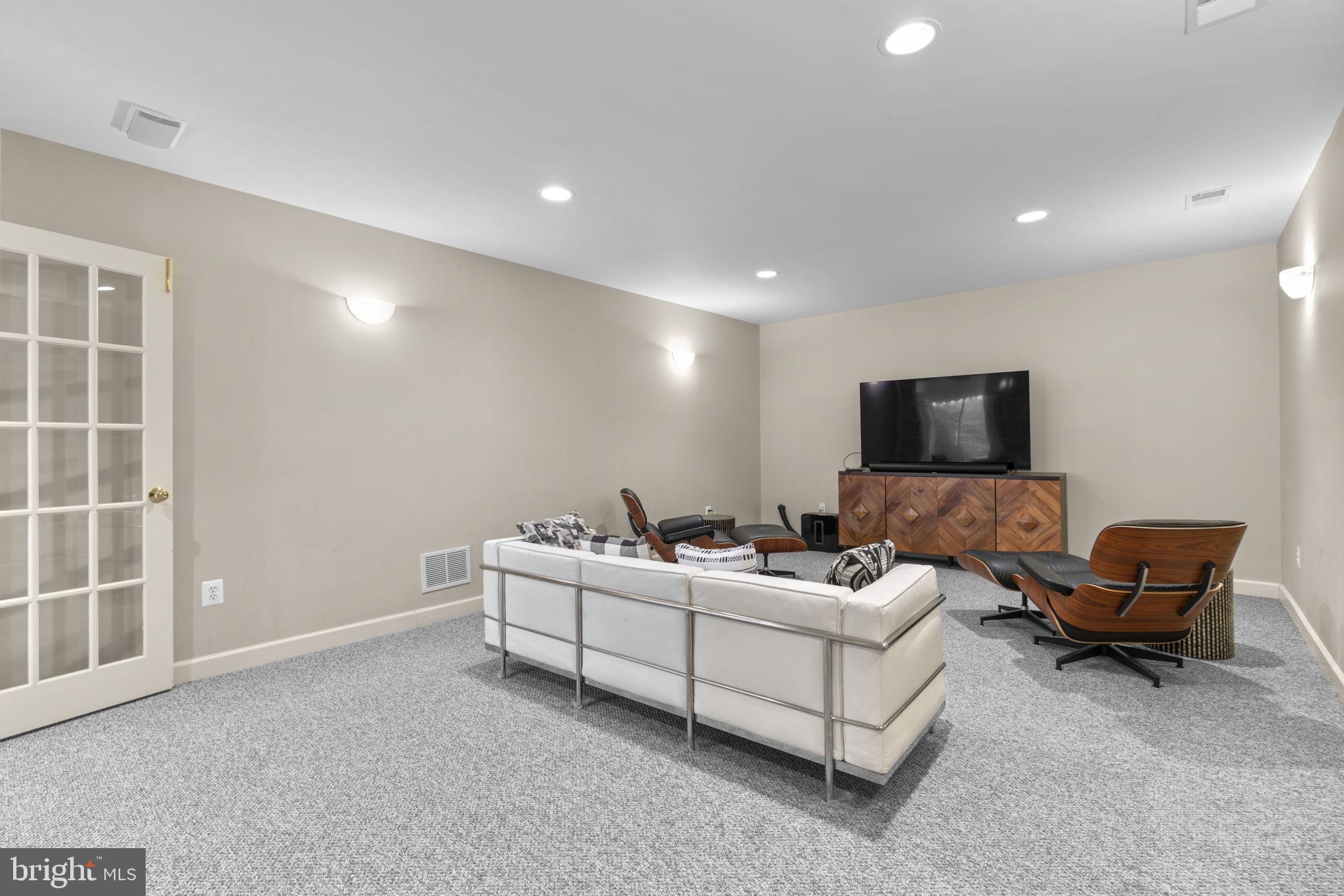 3091 Emerald Valley Road Ellicott City, MD 21042 - Photo 69 of 95 a living room with furniture and a flat screen tv