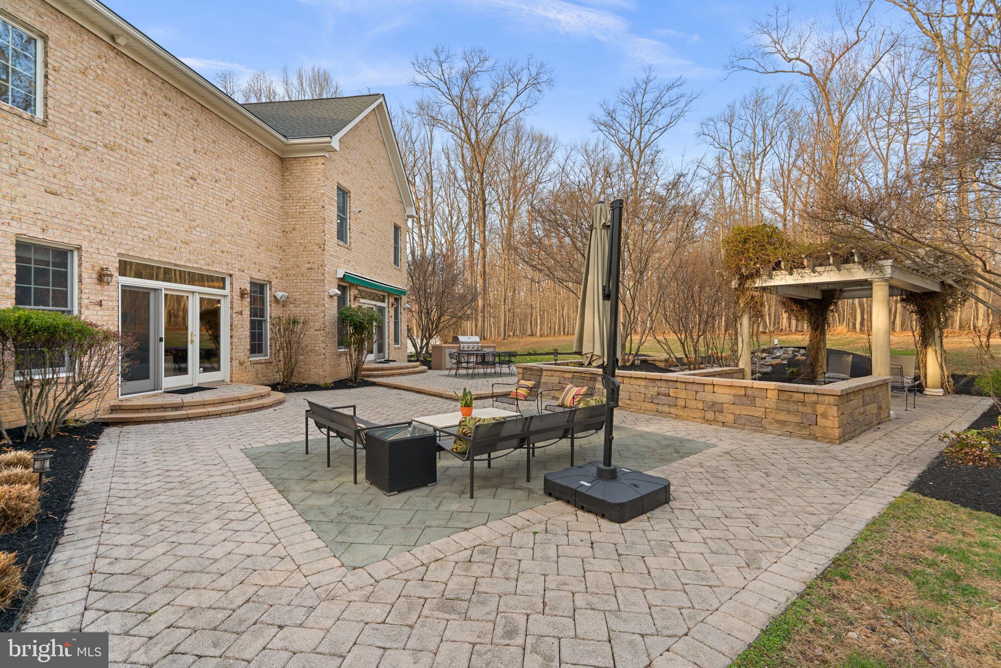 3091 Emerald Valley Road Ellicott City, MD 21042 - Photo 72 of 95 a view of a patio with couches table and chairs with wooden floor and fence