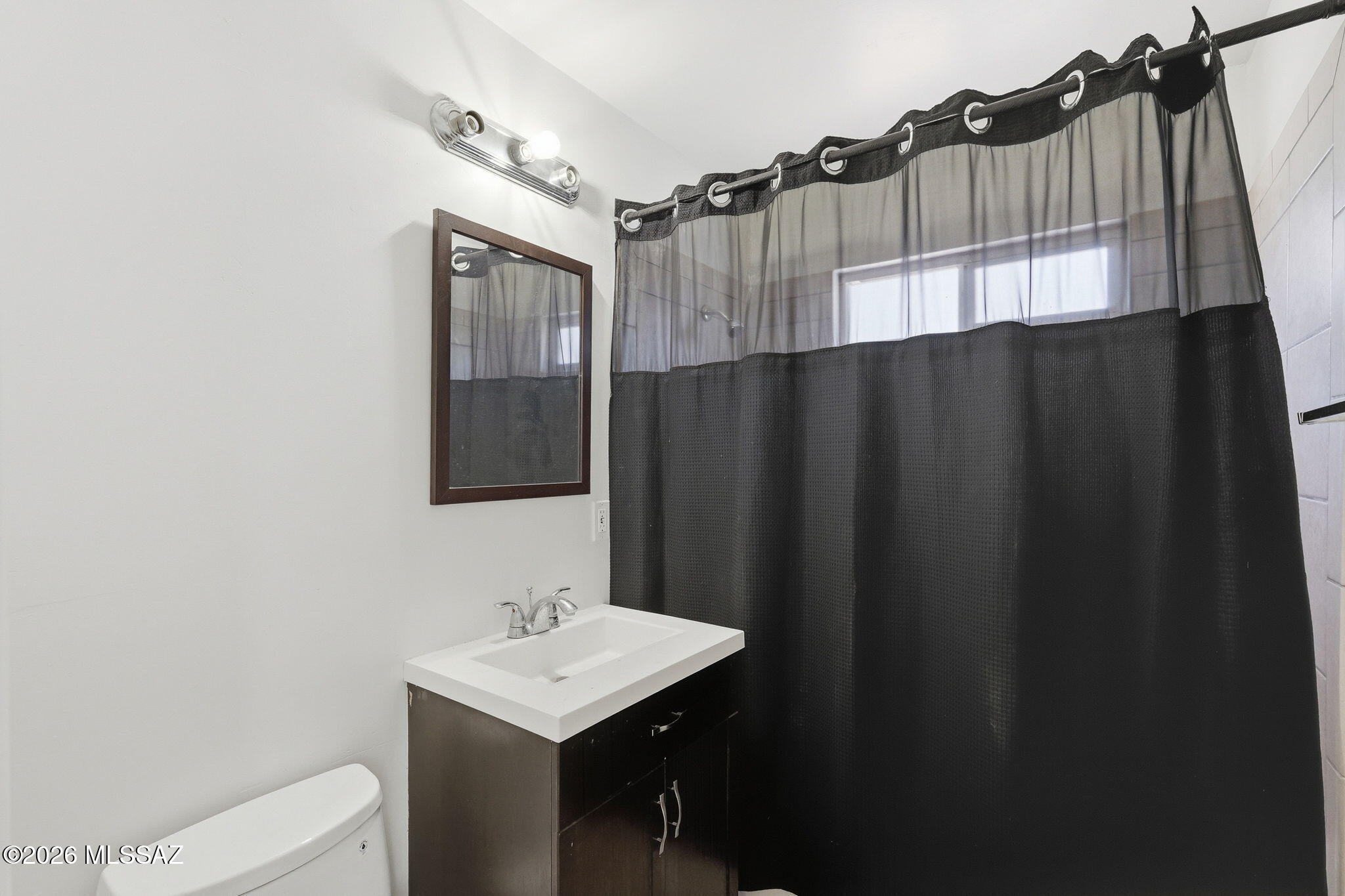 2721 East Fort Lowell Road Tucson, AZ 85716 - Photo 15 of 28 a bathroom with a sink a mirror and a toilet
