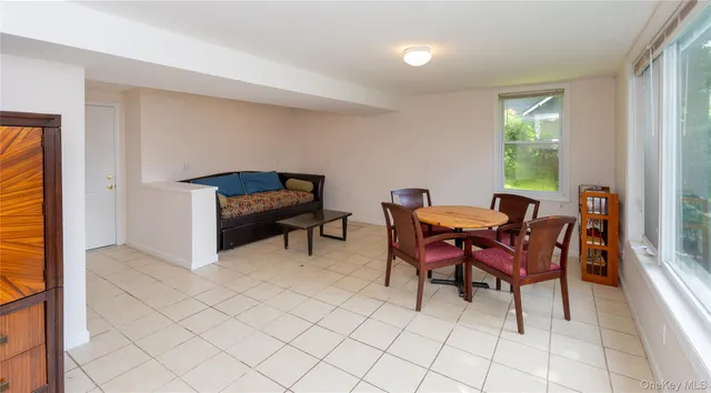 a view of a room with a large window and wooden floor