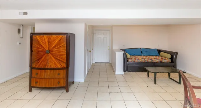 a view of room with window and wooden floor