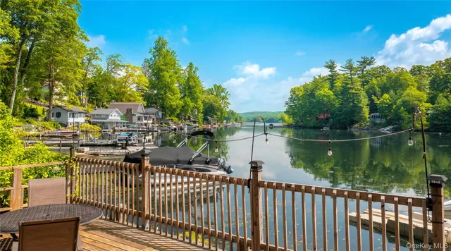 a living room with furniture a wooden floor and next to dining room