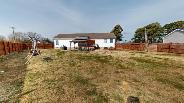 a kitchen with stainless steel appliances granite countertop a sink a stove and a wooden floors