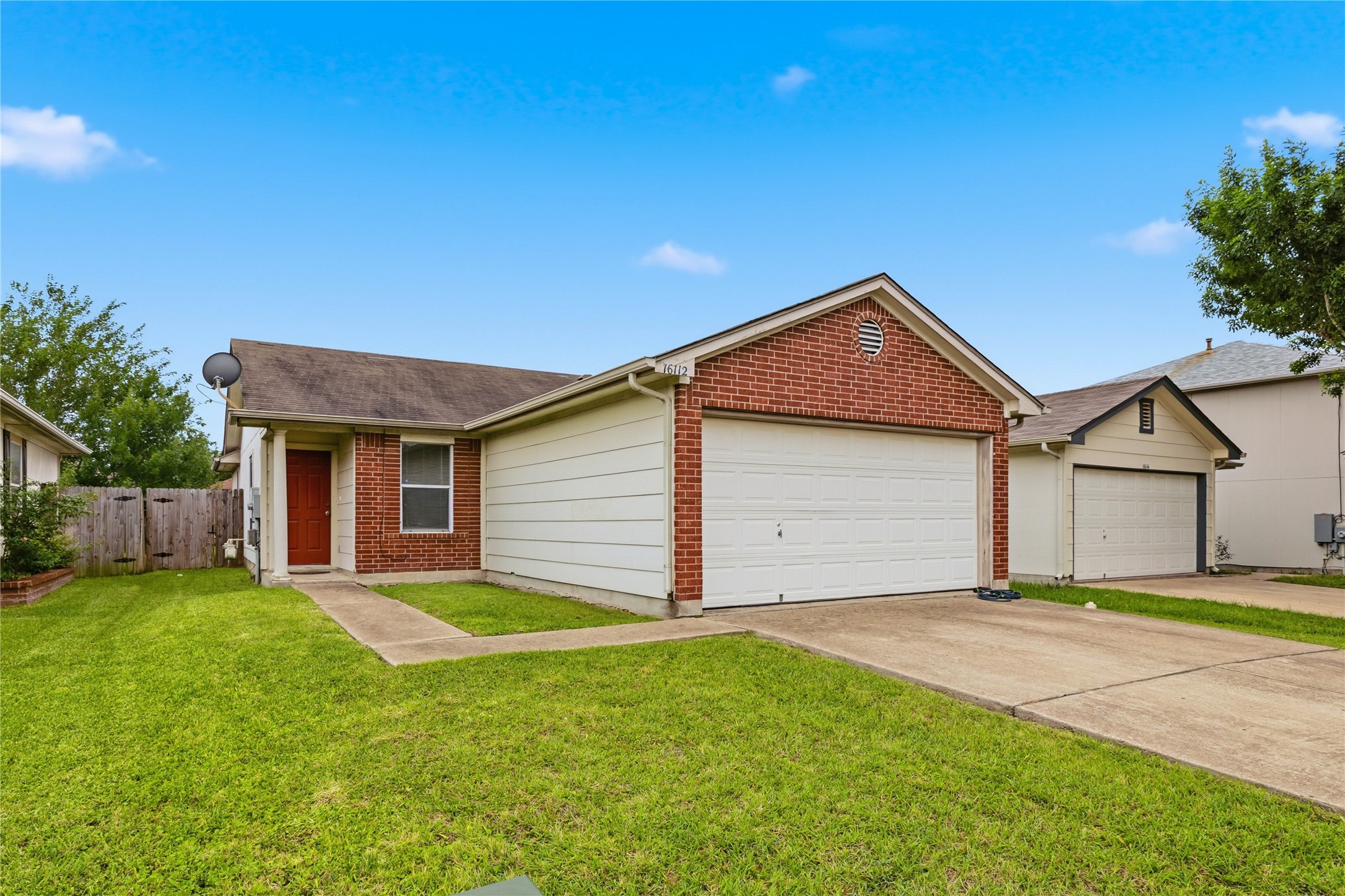 16112 Hamilton Point Circle Manor, TX 78653 - Photo 2 of 27 Brick and siding exterior with an attached garage