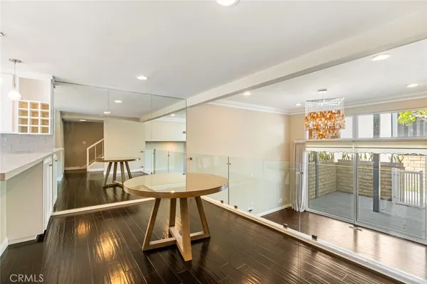 a kitchen with white cabinets and wooden floor
