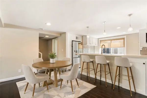 a dining room with furniture and wooden floor