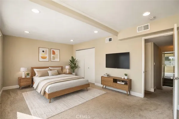 a bedroom with a bed and a flat screen tv
