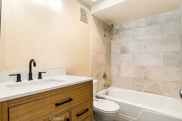 a bathroom with a sink a toilet and bathtub