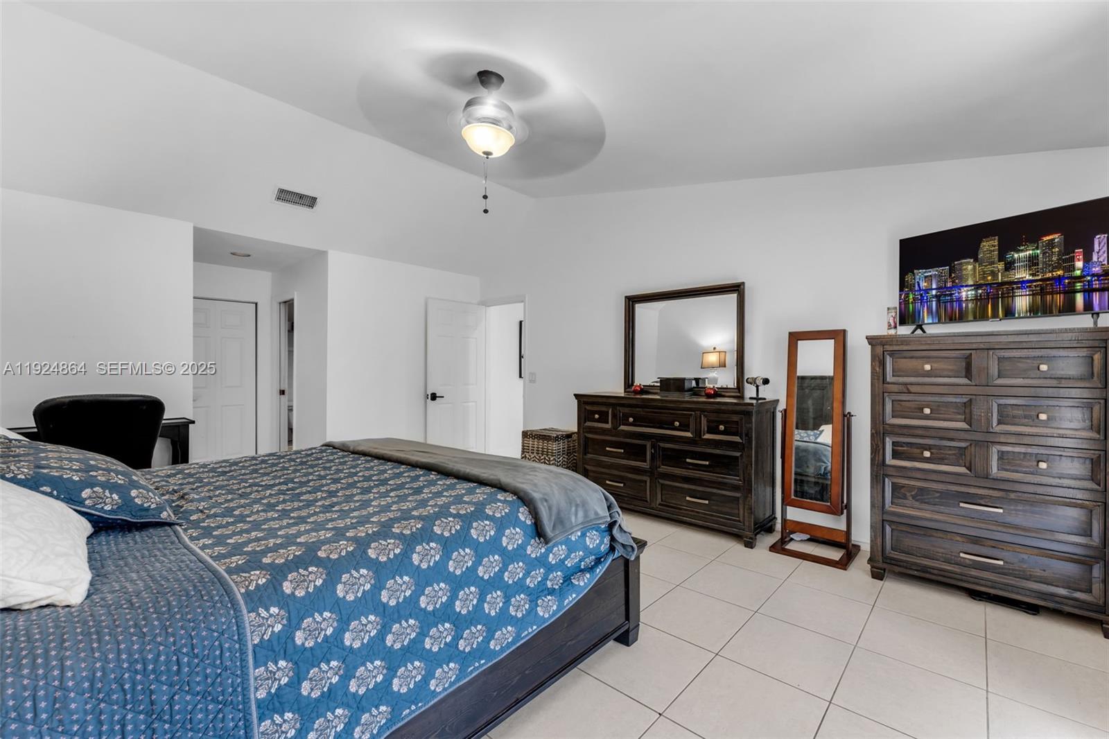 10020 Southwest 145th Place Miami, FL 33186 - Photo 17 of 35 a bedroom with a bed and a television