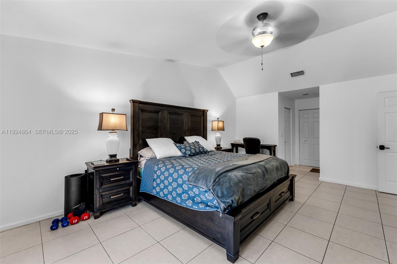 10020 Southwest 145th Place Miami, FL 33186 - Photo 18 of 35 a bedroom with a bed and dresser