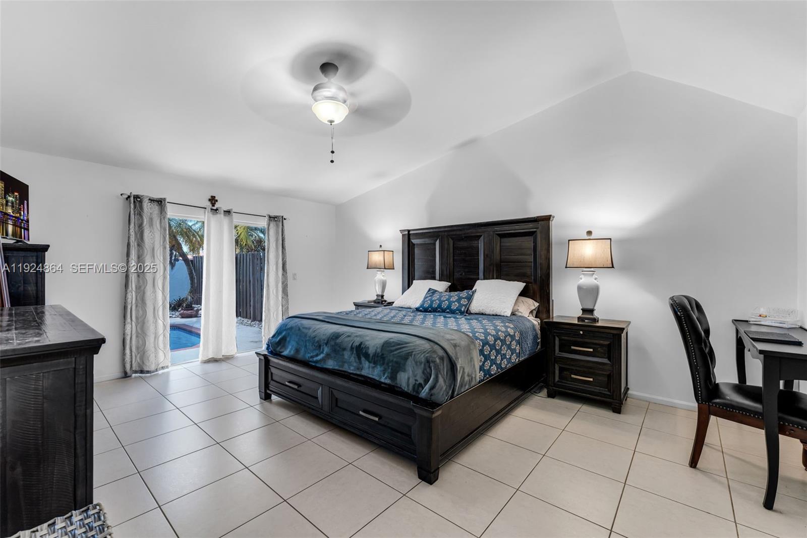 10020 Southwest 145th Place Miami, FL 33186 - Photo 19 of 35 a spacious bedroom with a bed and a chair in it