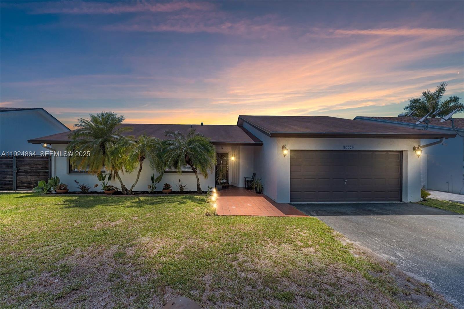 10020 Southwest 145th Place Miami, FL 33186 - Photo 2 of 35 a view of a house with a yard and garage