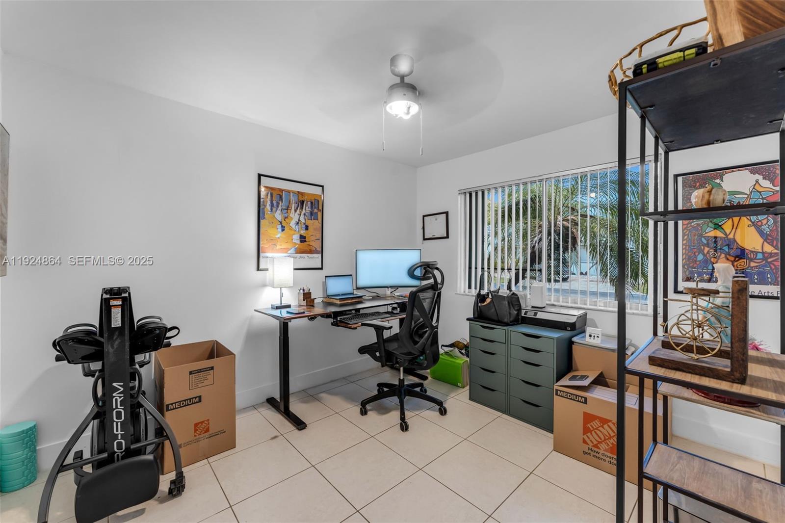 10020 Southwest 145th Place Miami, FL 33186 - Photo 22 of 35 a view of a workspace with furniture and a window