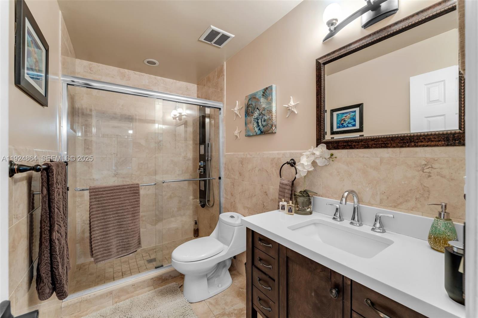 10020 Southwest 145th Place Miami, FL 33186 - Photo 25 of 35 a bathroom with a sink toilet and shower