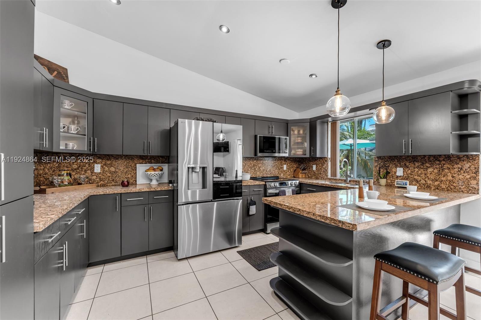 10020 Southwest 145th Place Miami, FL 33186 - Photo 29 of 35 a large kitchen with granite countertop lots of counter space and stainless steel appliances
