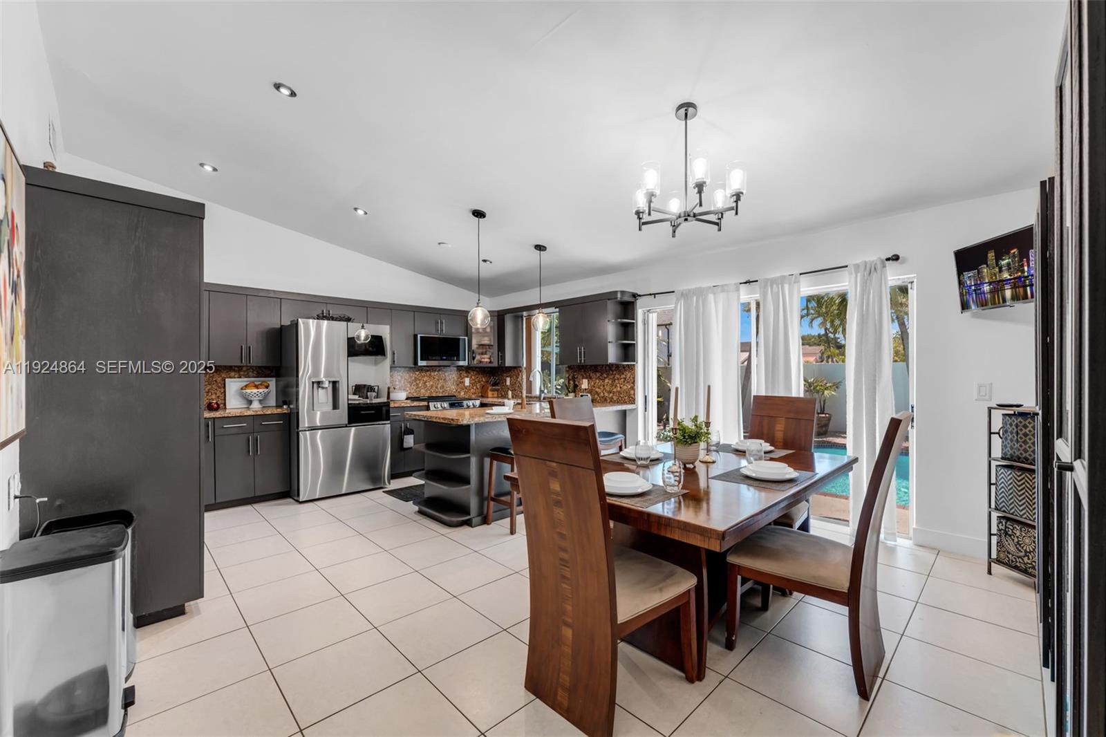 10020 Southwest 145th Place Miami, FL 33186 - Photo 30 of 35 a view of a dining room with furniture and a chandelier