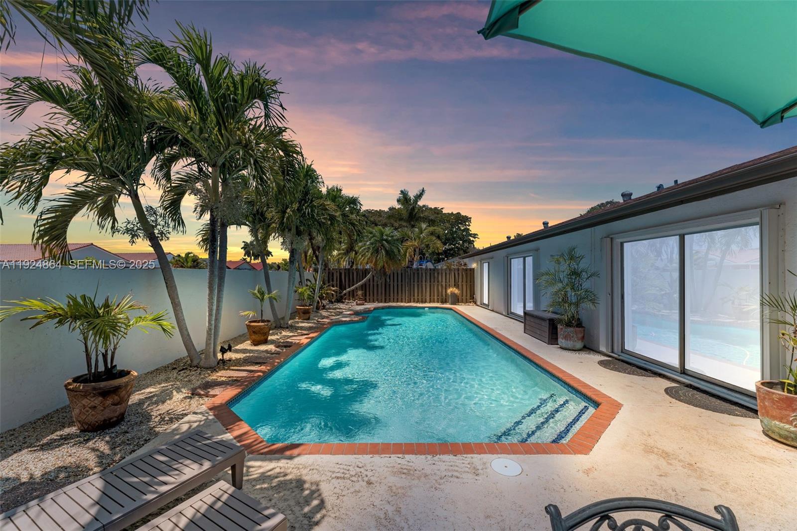 10020 Southwest 145th Place Miami, FL 33186 - Photo 3 of 35 a backyard of a house with seating space