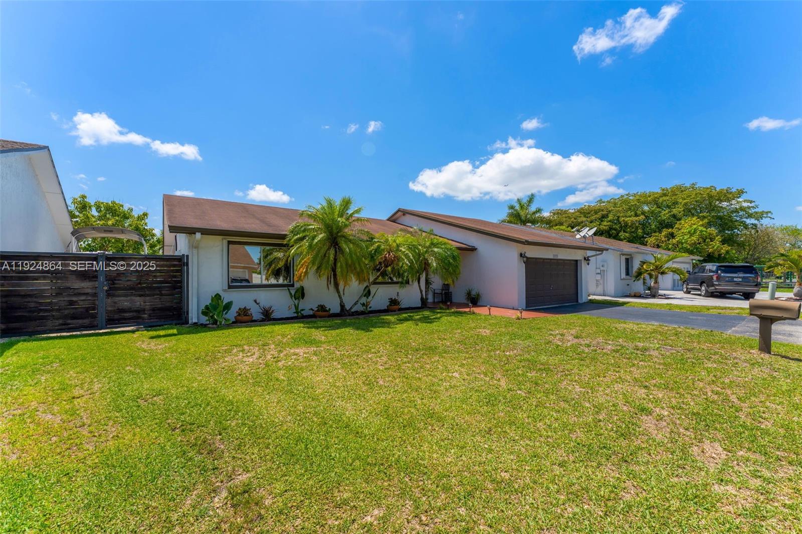 10020 Southwest 145th Place Miami, FL 33186 - Photo 35 of 35 a front view of a house with garden