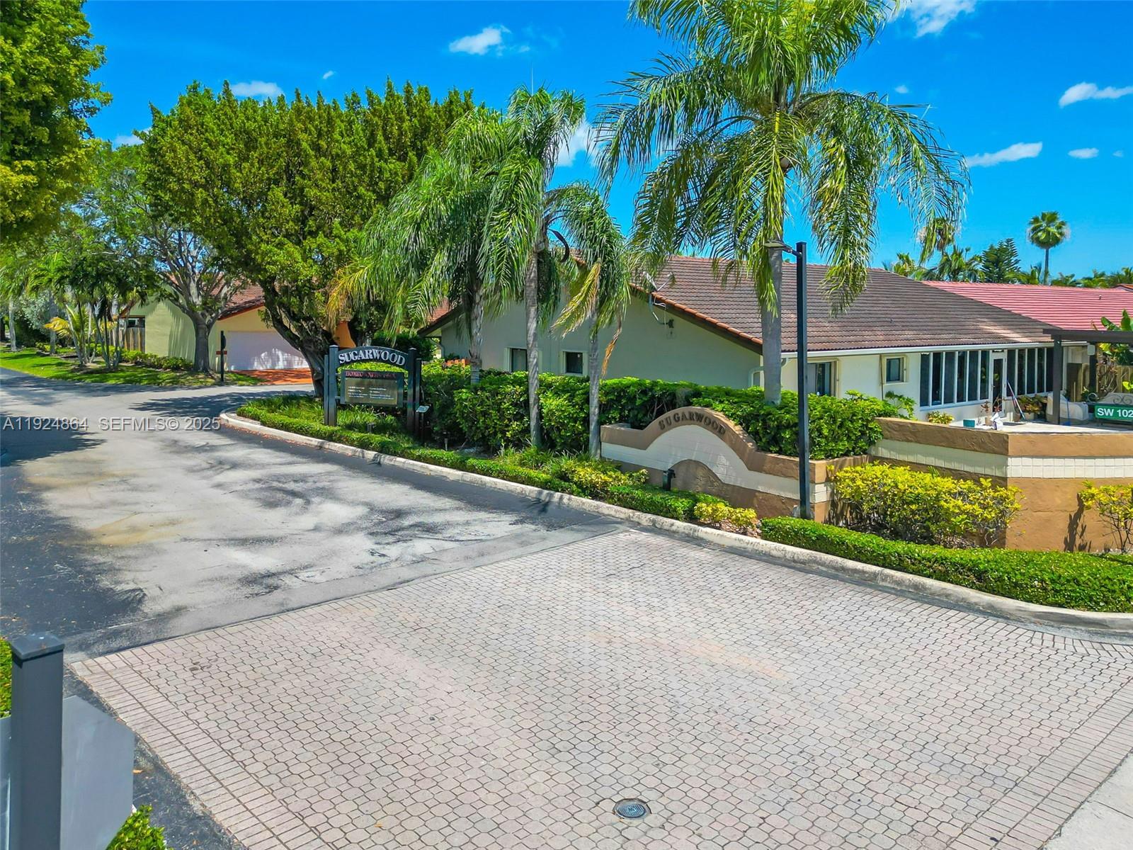 10020 Southwest 145th Place Miami, FL 33186 - Photo 4 of 35 a view of a house with a yard and palm trees