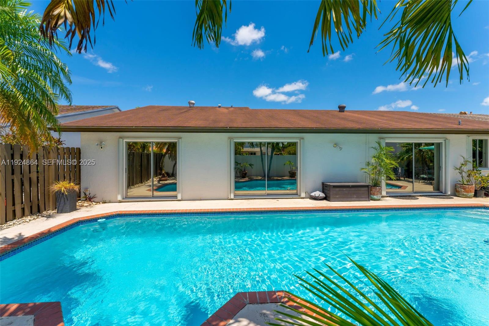 10020 Southwest 145th Place Miami, FL 33186 - Photo 9 of 35 a view of a house with a swimming pool and a chairs