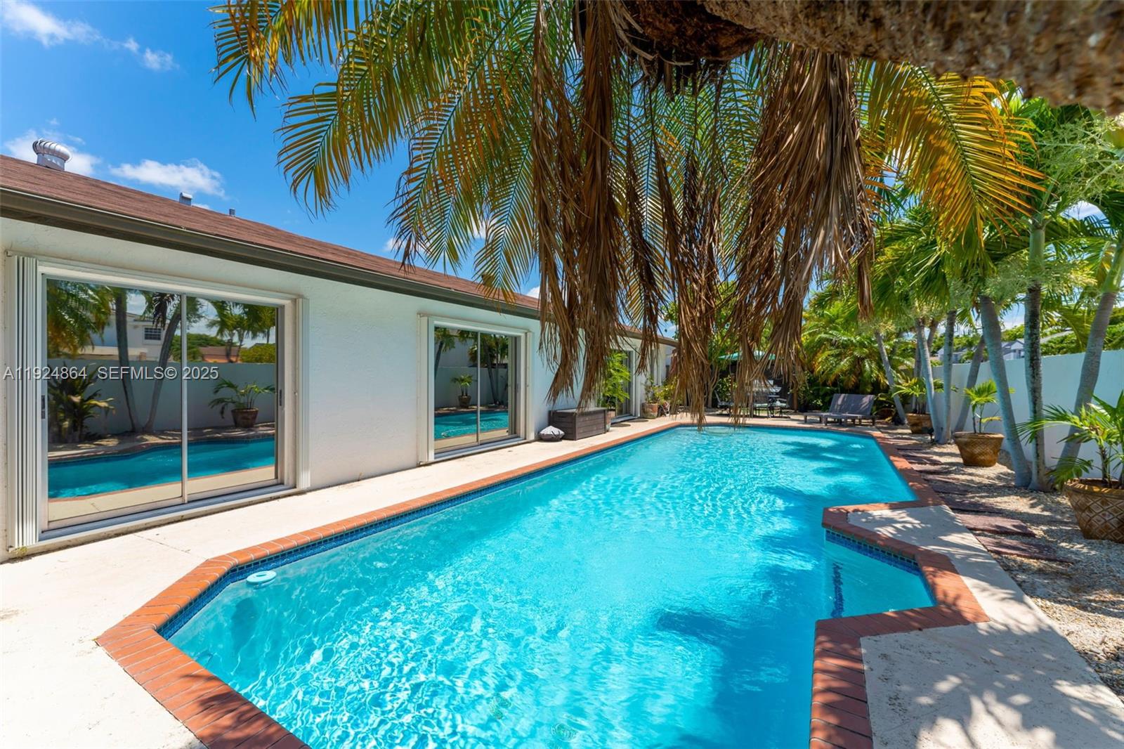 10020 Southwest 145th Place Miami, FL 33186 - Photo 10 of 35 a swimming pool with outdoor seating and yard