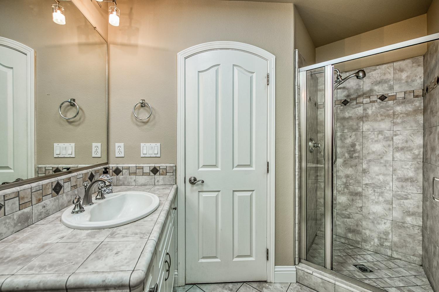 4679 North Island View Clovis, CA 93619 - Photo 14 of 55 a bathroom with a sink and a mirror