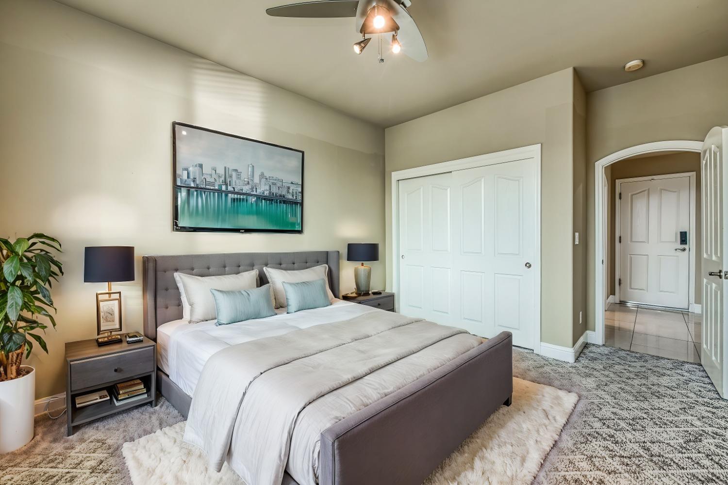 4679 North Island View Clovis, CA 93619 - Photo 15 of 55 a spacious bedroom with a bed and a couch