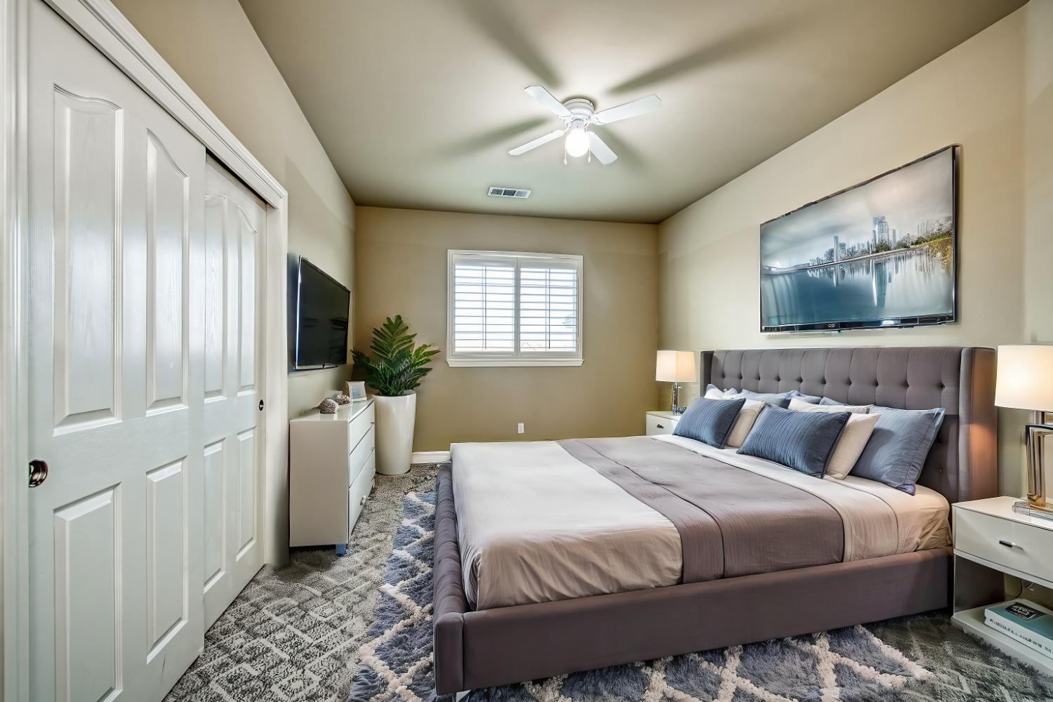 4679 North Island View Clovis, CA 93619 - Photo 18 of 55 a bedroom with a bed and a chandelier