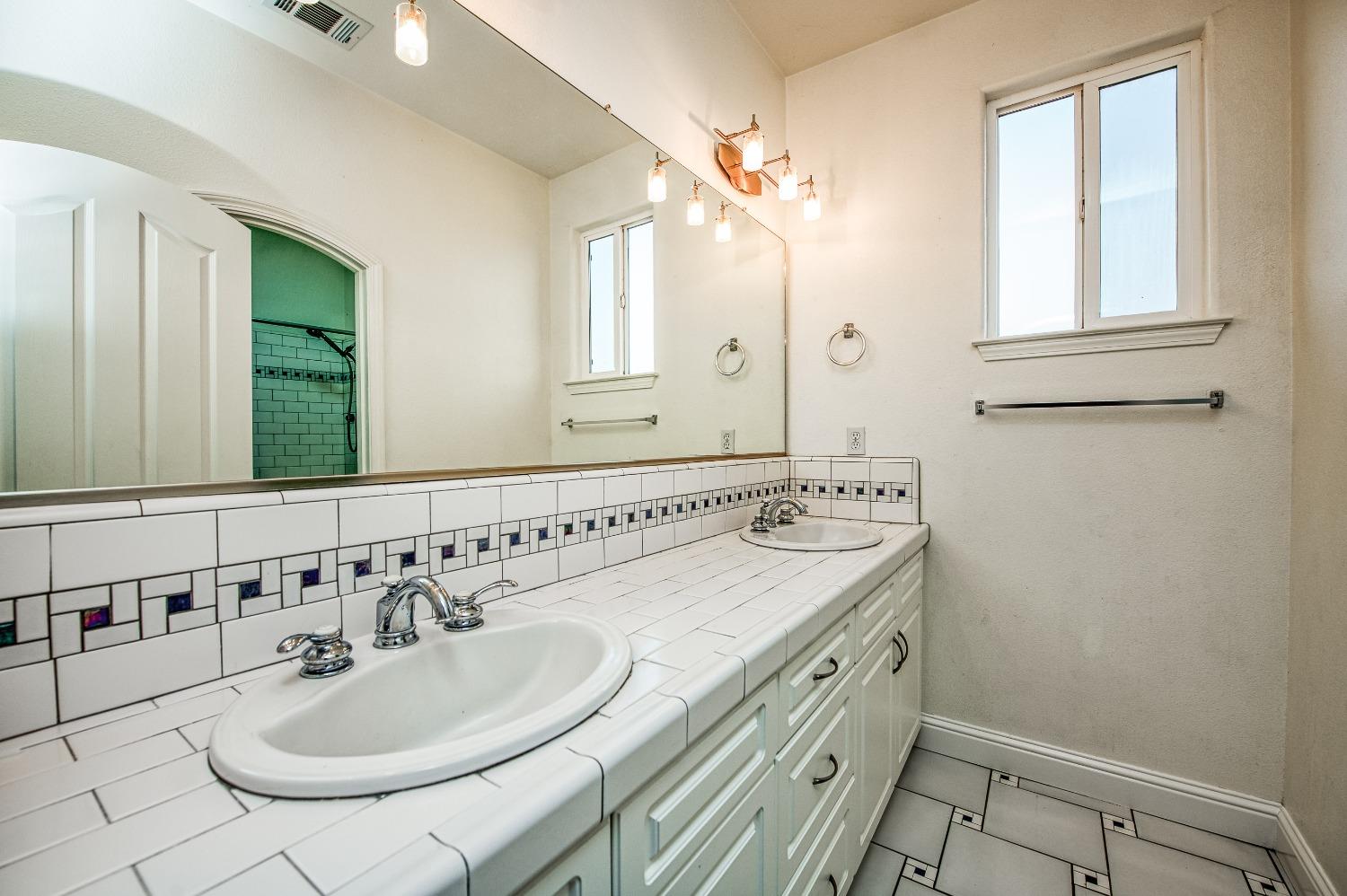 4679 North Island View Clovis, CA 93619 - Photo 19 of 55 a bathroom with a sink and a mirror