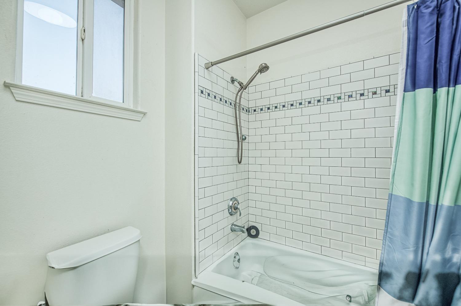 4679 North Island View Clovis, CA 93619 - Photo 20 of 55 a bathroom with a bathtub and a shower