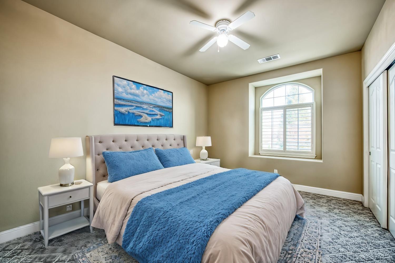 4679 North Island View Clovis, CA 93619 - Photo 21 of 55 a bedroom with a large bed and a window