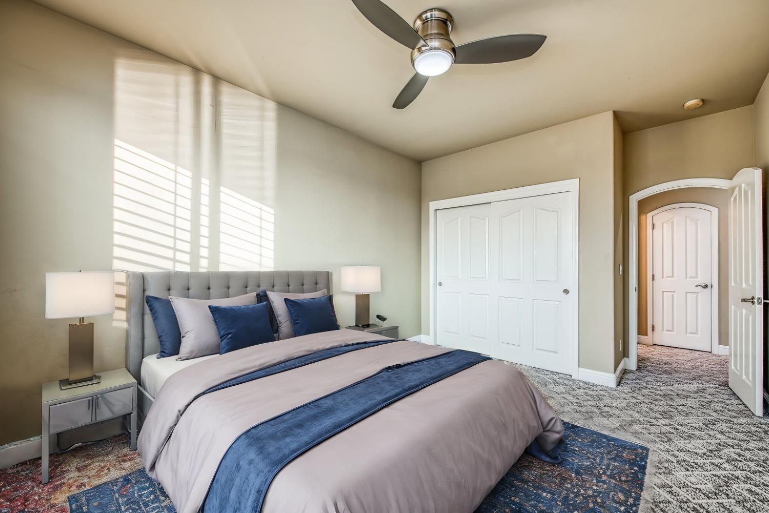 4679 North Island View Clovis, CA 93619 - Photo 22 of 55 a bedroom with a large bed and a chandelier