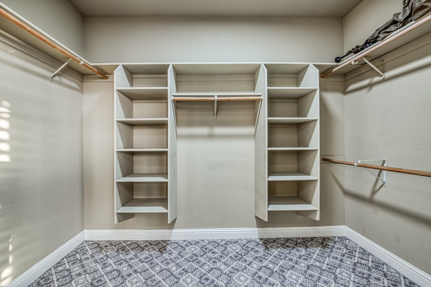 4679 North Island View Clovis, CA 93619 - Photo 26 of 55 a view of walk in closet with empty racks