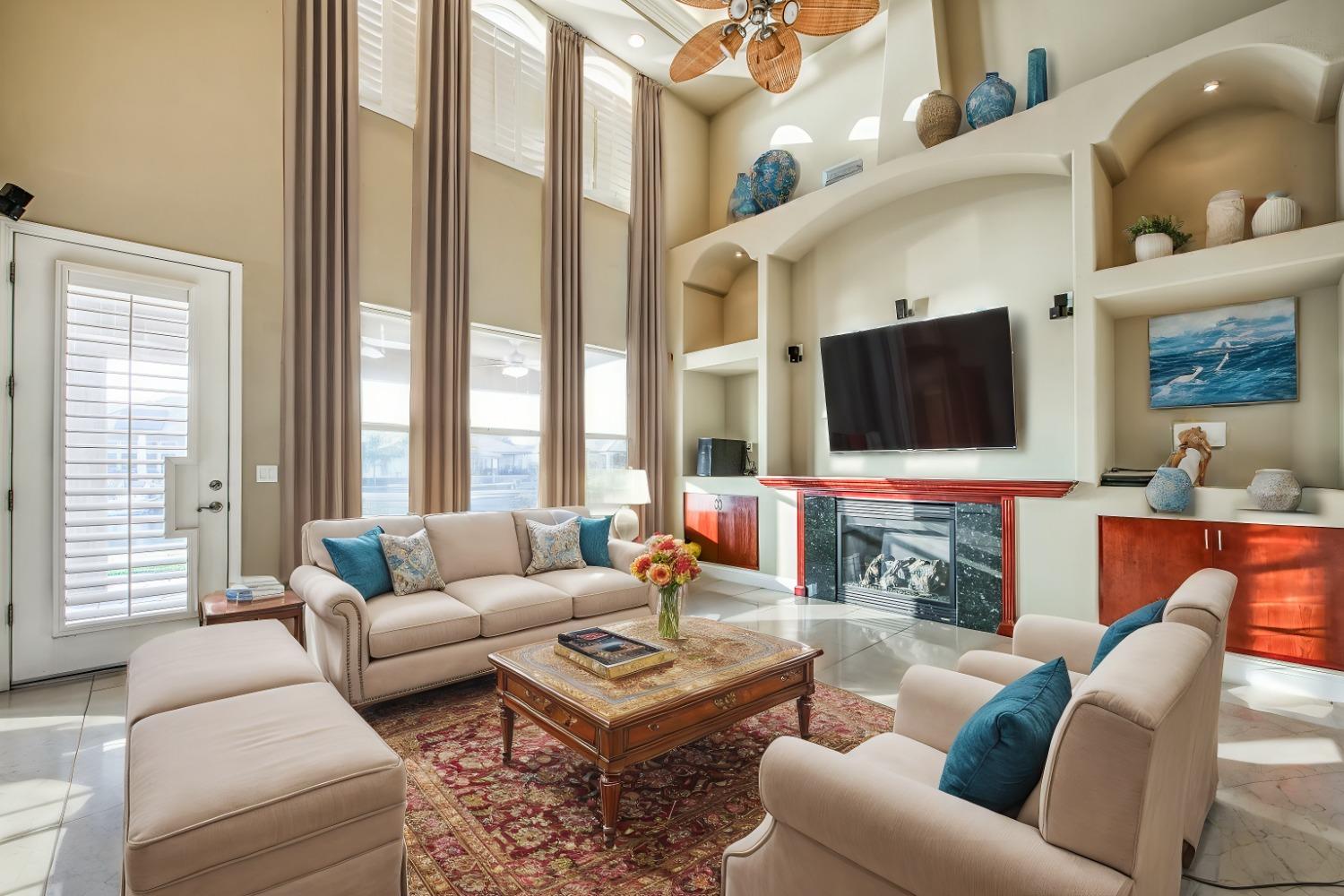 4679 North Island View Clovis, CA 93619 - Photo 3 of 55 a living room with fireplace furniture and a flat screen tv