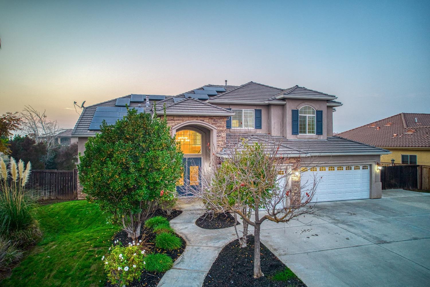 4679 North Island View Clovis, CA 93619 - Photo 42 of 55 a front view of a house with a yard