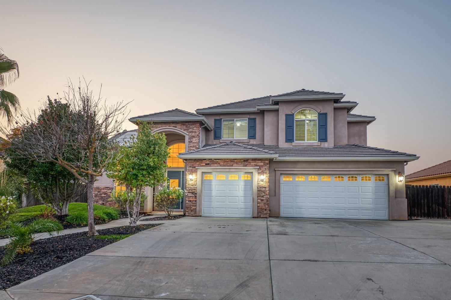 4679 North Island View Clovis, CA 93619 - Photo 44 of 55 a front view of a house with a yard and garage