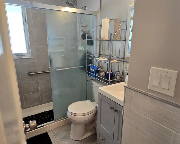 a bathroom with a toilet a sink and shower