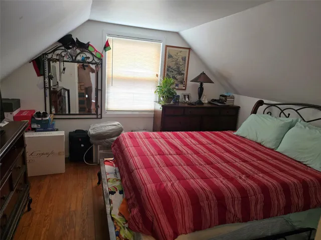 a bedroom with a bed and window