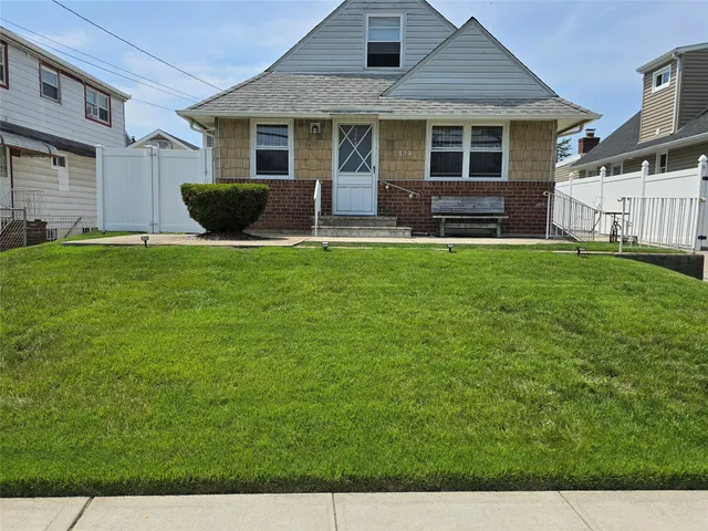 a front view of house with yard and outdoor seating