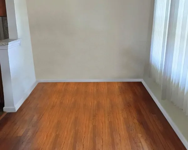 a view of wooden floor in a small bathroom