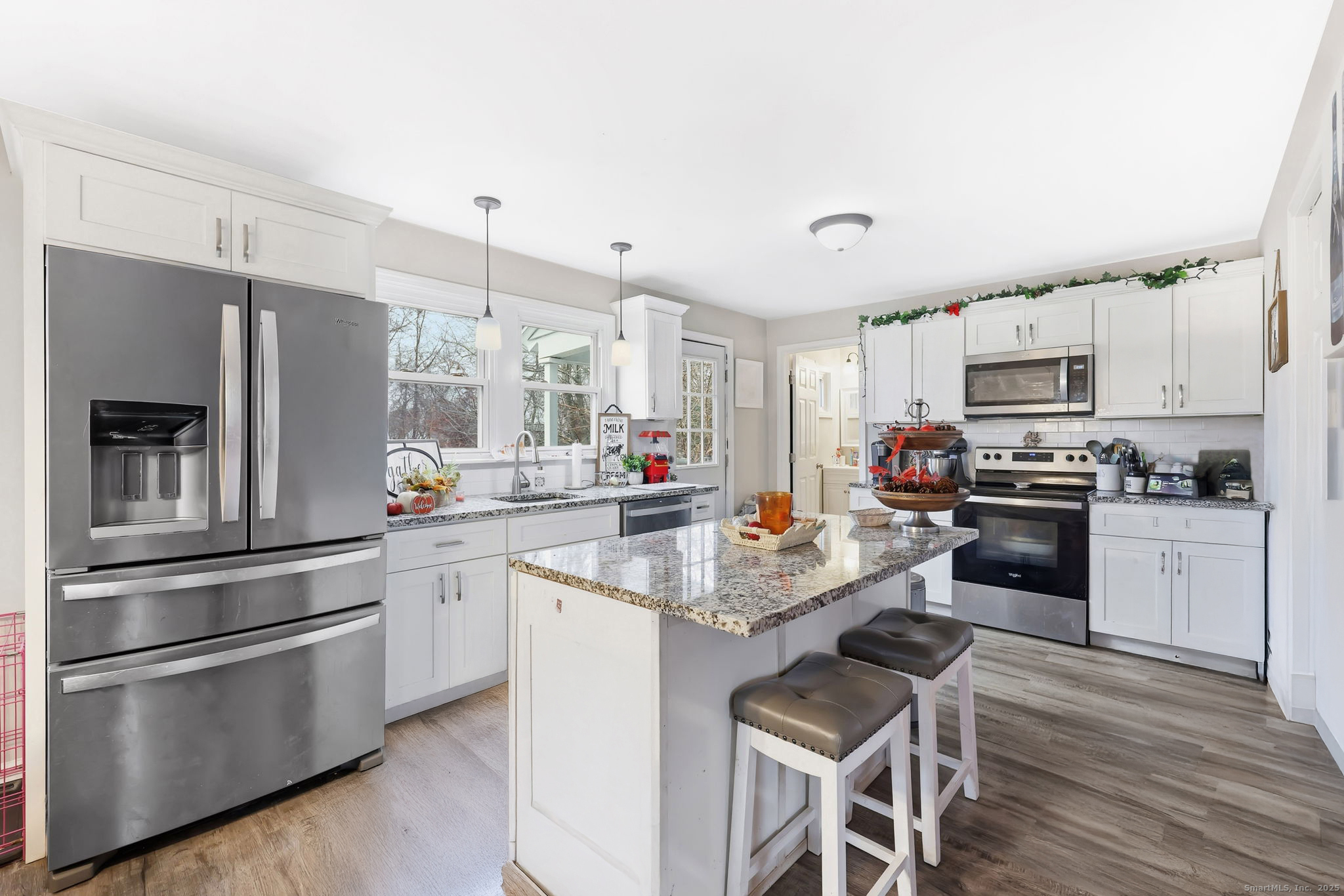 a kitchen with granite countertop stainless steel appliances a sink and cabinets
