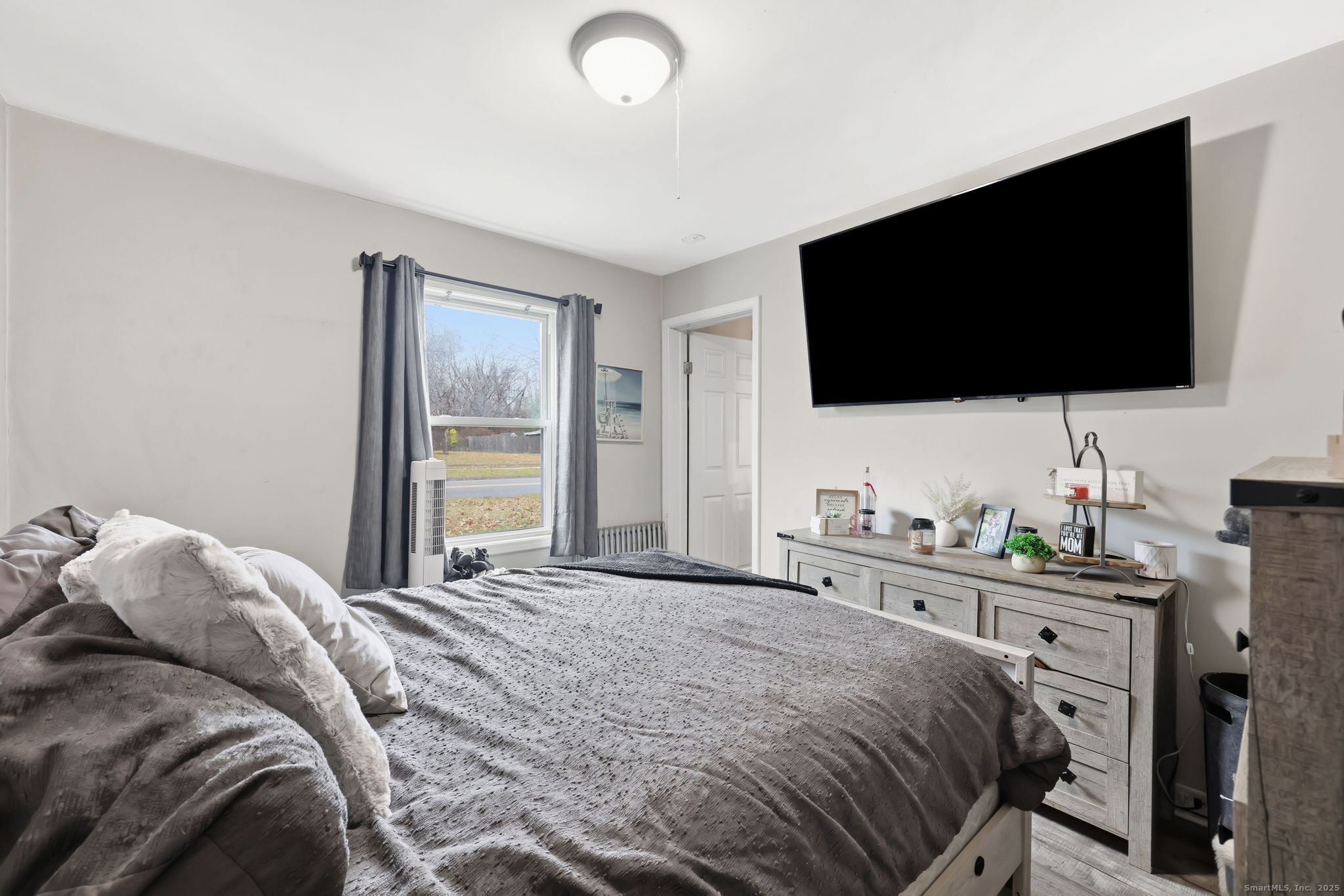 16 Brainard Road Enfield, CT 06082 - Photo 17 of 28 a bedroom with a bed and a flat screen tv