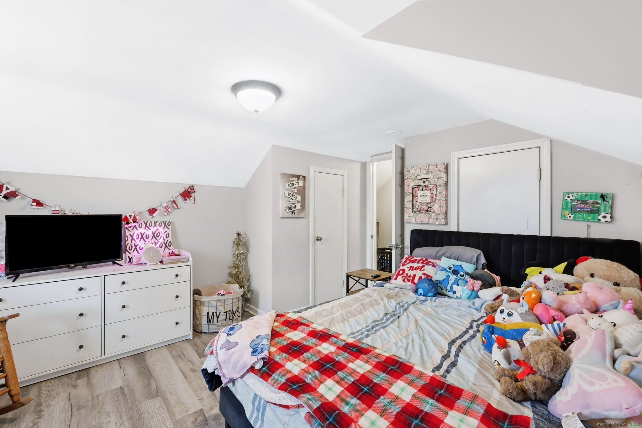 16 Brainard Road Enfield, CT 06082 - Photo 23 of 28 a bedroom with a bed a flat tv screen and a dresser