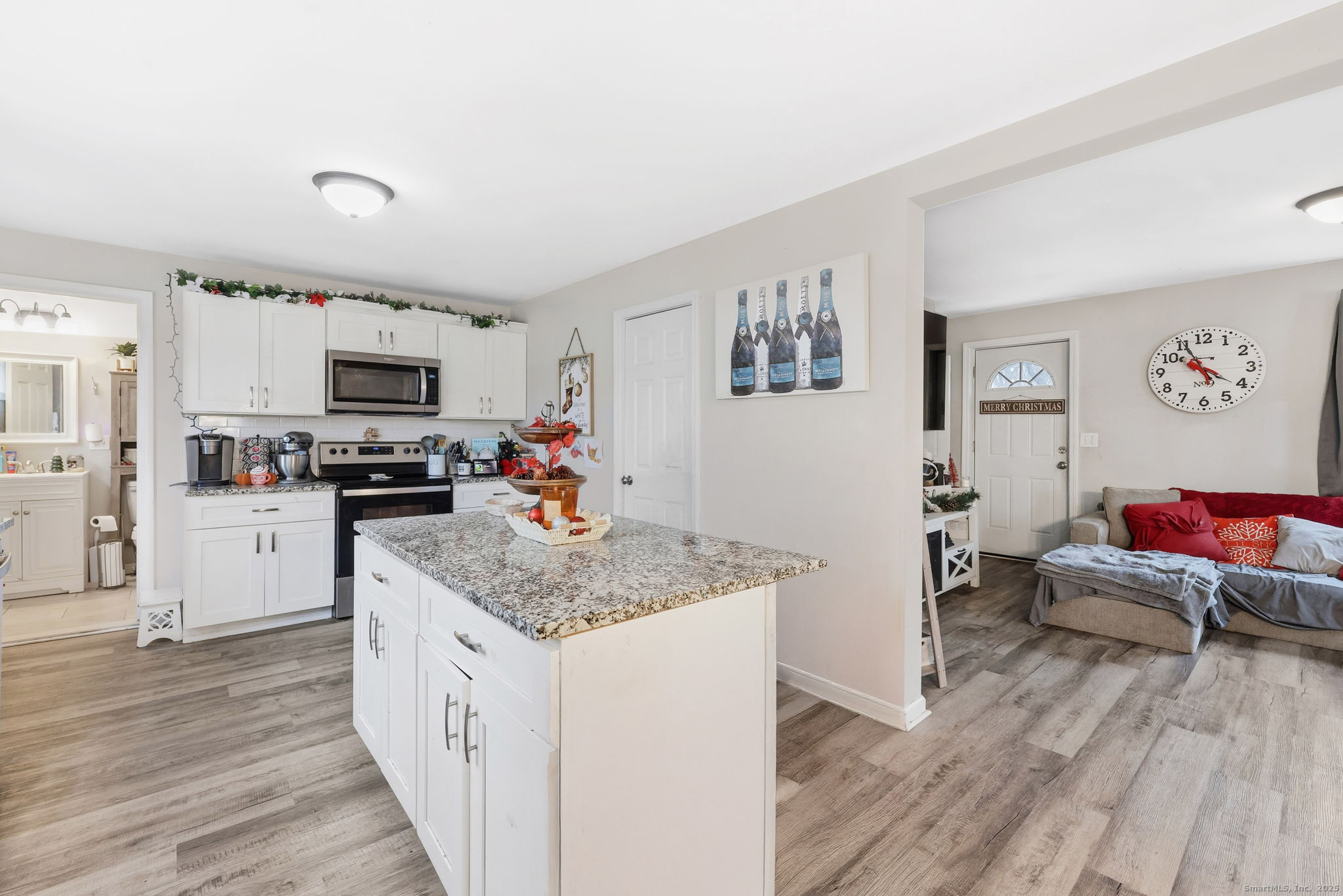 16 Brainard Road Enfield, CT 06082 - Photo 6 of 28 a kitchen with stainless steel appliances granite countertop a refrigerator oven a sink dishwasher and white cabinets with wooden floor